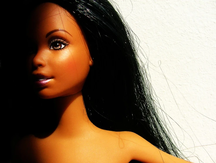 a doll with a white and black hair is wearing a 