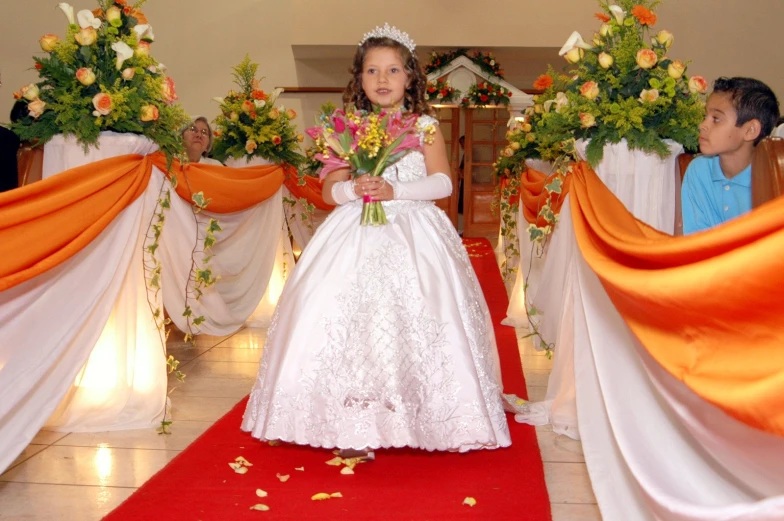 two young children are dressed up on a red carpet