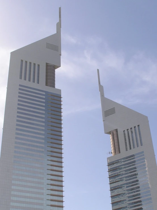 two tall buildings with a sky background