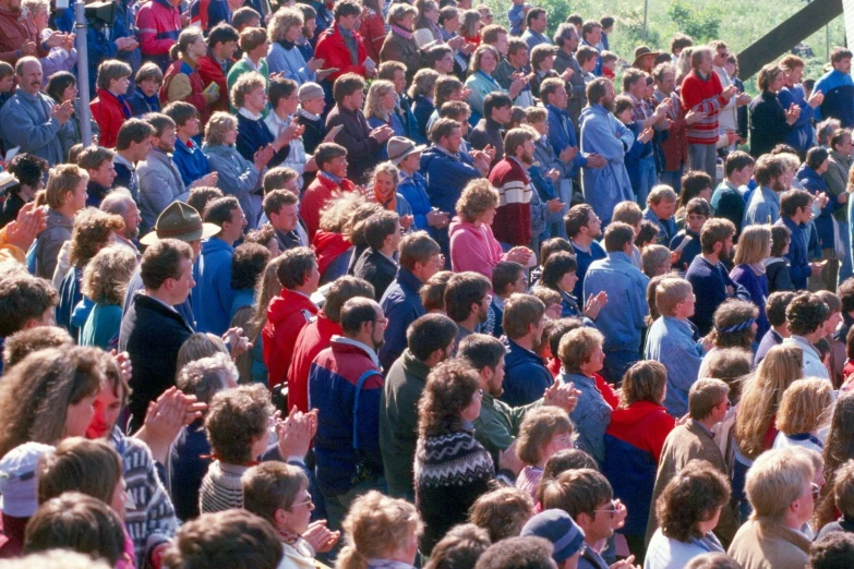 a crowd of people gathered around in a street