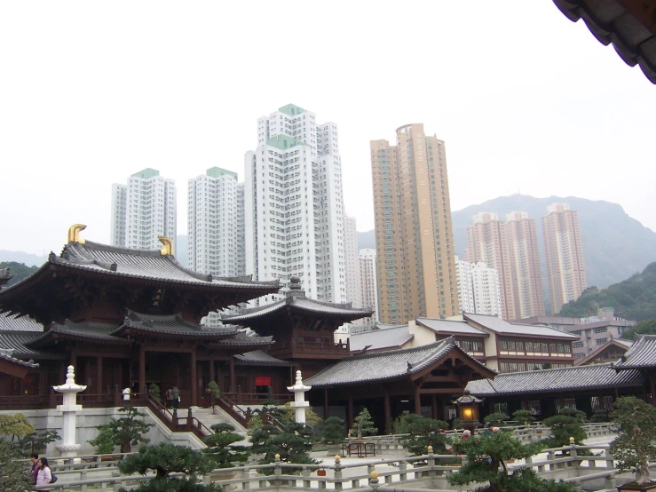 a chinese temple, surrounded by buildings in the background