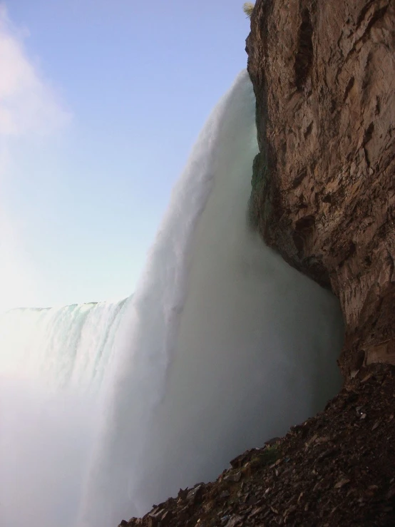 large wave in water at top of tall cliff