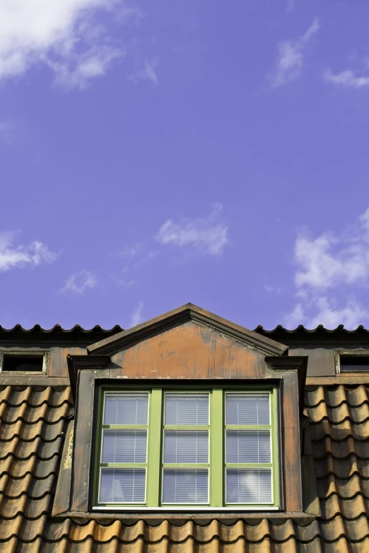 a wooden window next to a red tiled roof