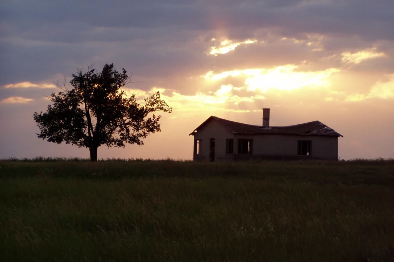 a large old house in the middle of a field