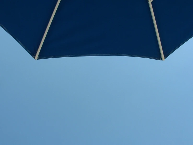 the blue umbrella is above the blue sky