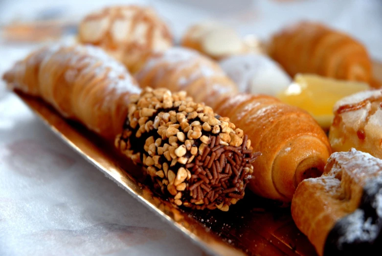 an assortment of pastry goods sitting on a plate