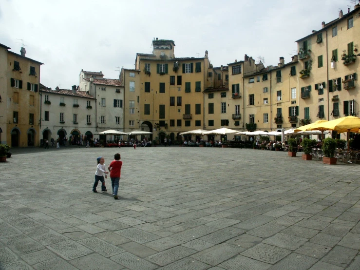 two boys are standing near each other on the square