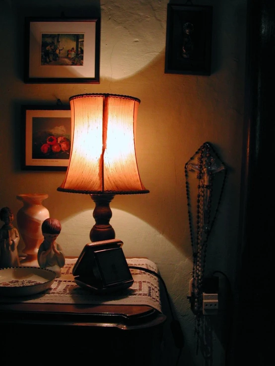 a night table and lamp set up with two stuffed animals