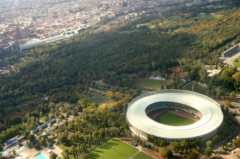 aerial view of a large stadium with grass and trees