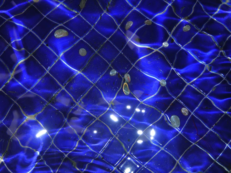 a large mesh piece with some balls of light and blue background