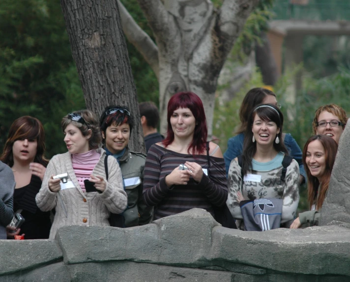 a group of people smiling in an enclosure
