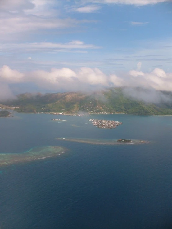 some green islands sitting in the middle of some water