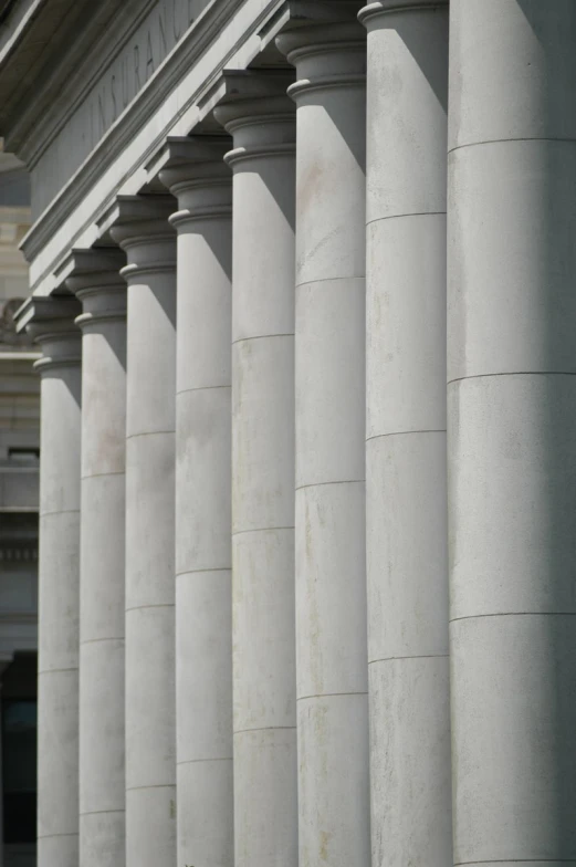 an older woman riding a skateboard near columns