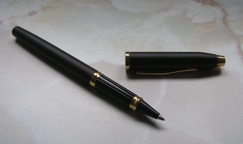 a fountain pen next to its holder on a table