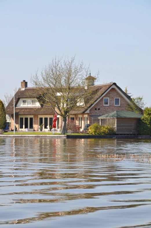 a large house sitting on top of a body of water