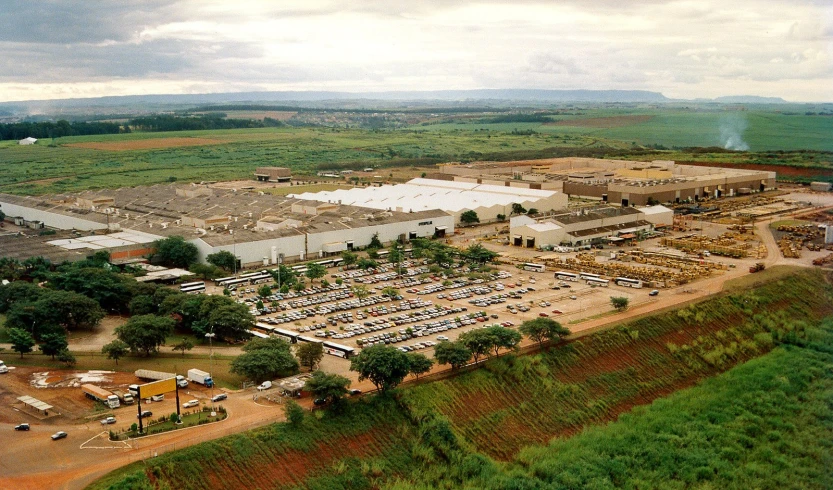 a bird's eye view of a factory with a lot and buildings