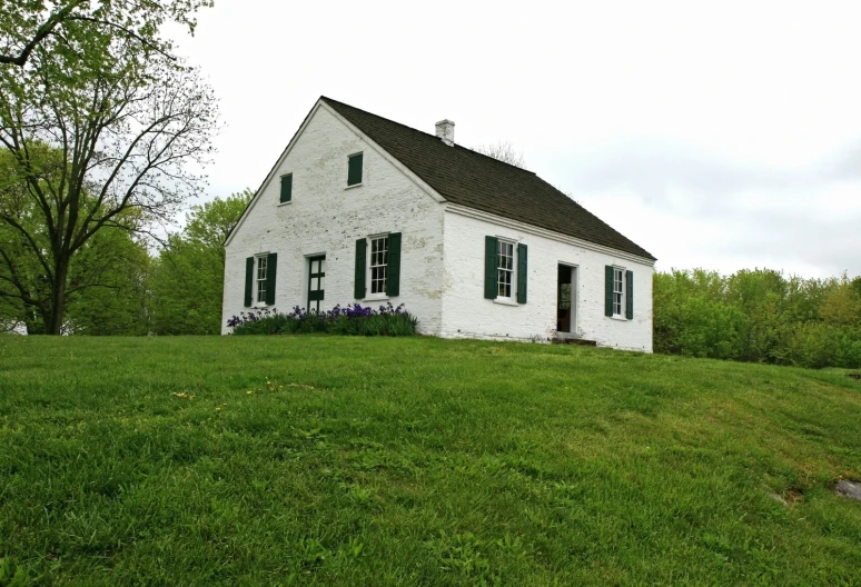 an old white house with a black roof