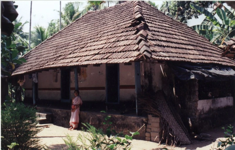 woman standing in front of a small house