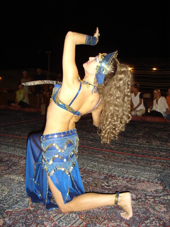 a woman wearing a belly wrap dancing around
