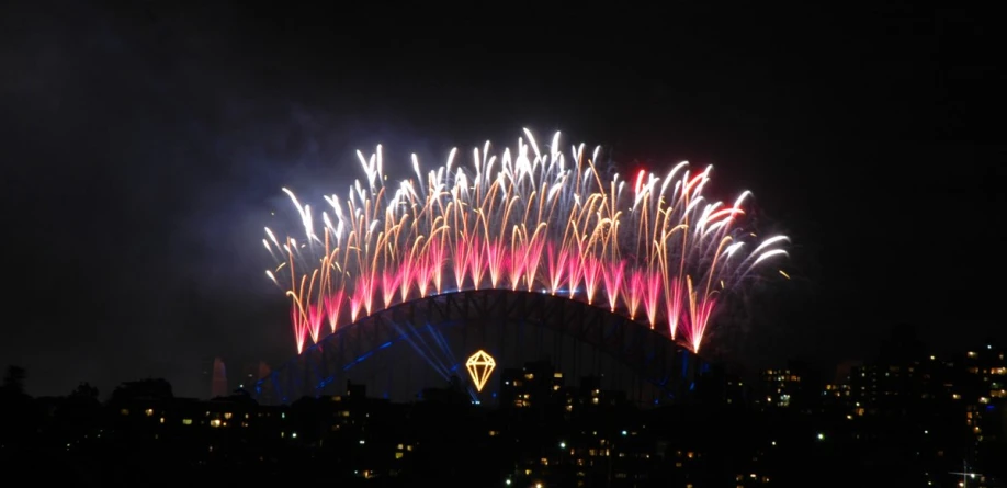 fireworks are lit up in the sky above a city