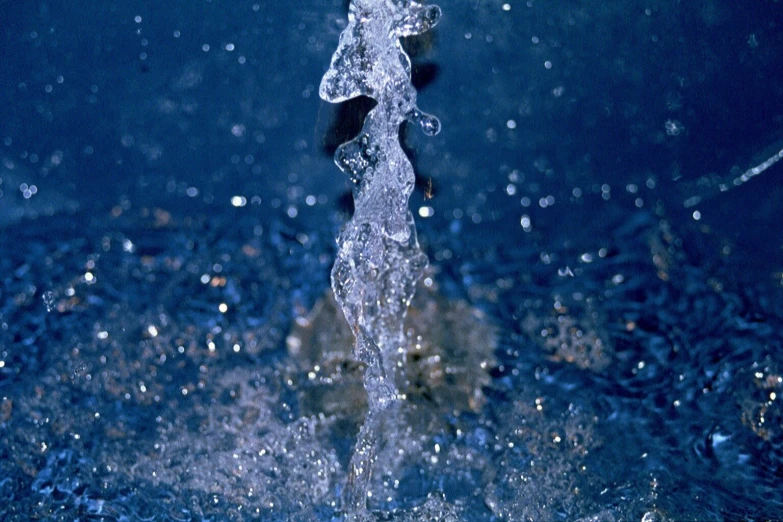 a water spigot with droplets of water on it's face