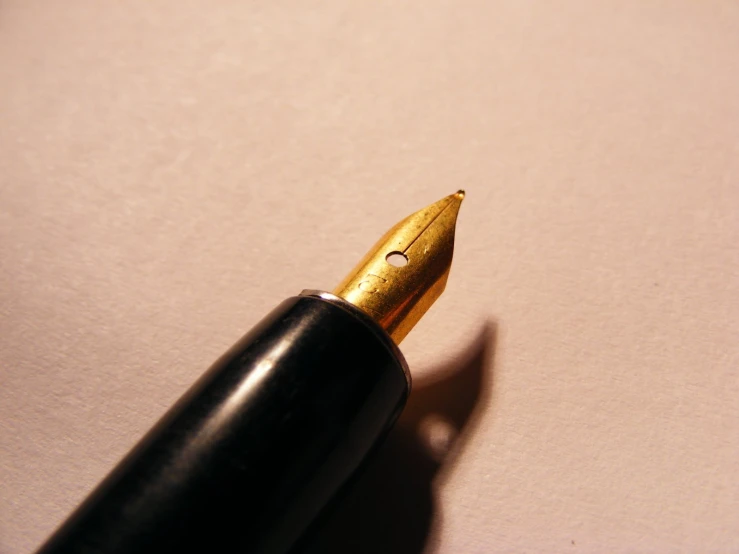 a pen on top of a table next to some other items