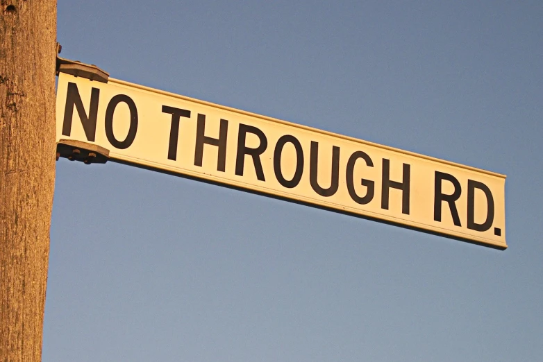 a street sign showing no through rr with a sky background