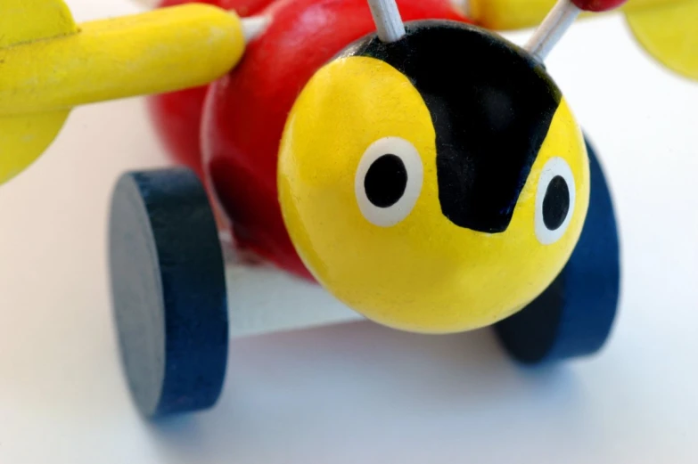 a toy airplane with a red apple attached to it