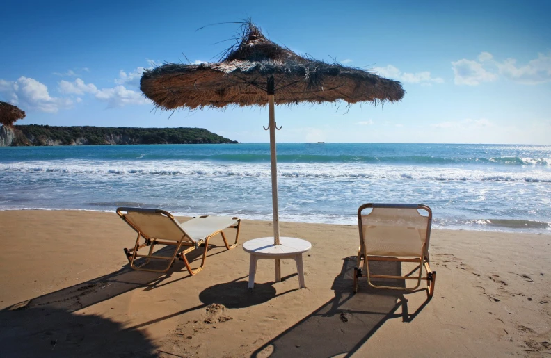 chairs and umbrella on the beach and ocean