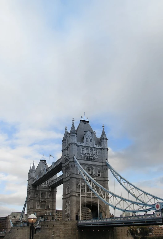 a bridge over some water and buildings and a sky