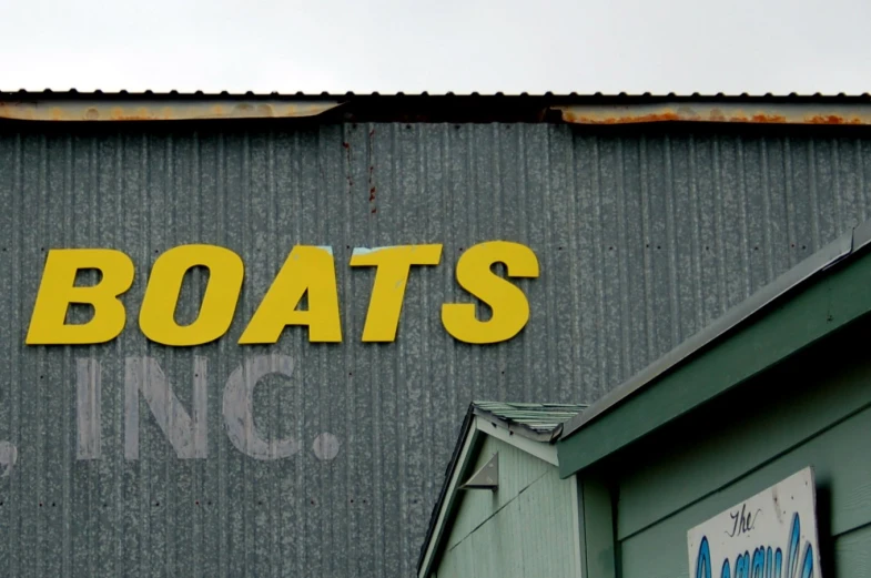 the words boats on a wall above a building