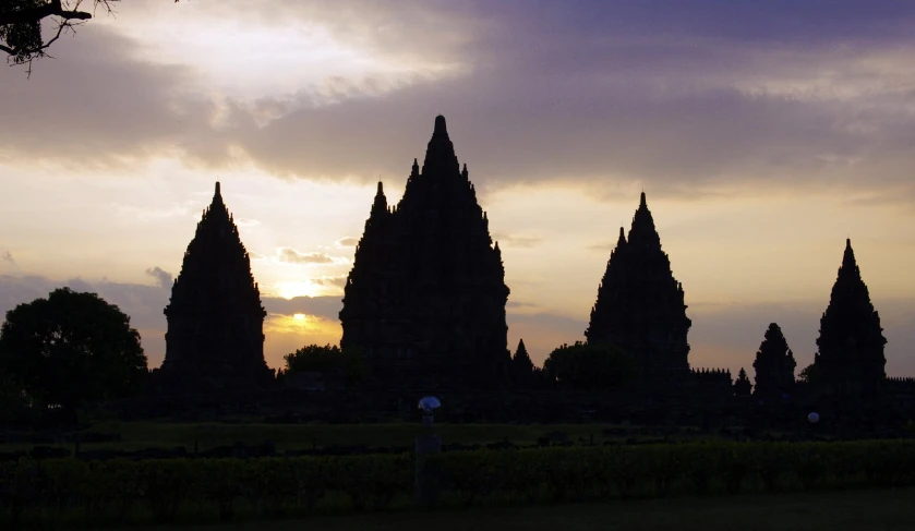 a large group of tall buildings in the sunset