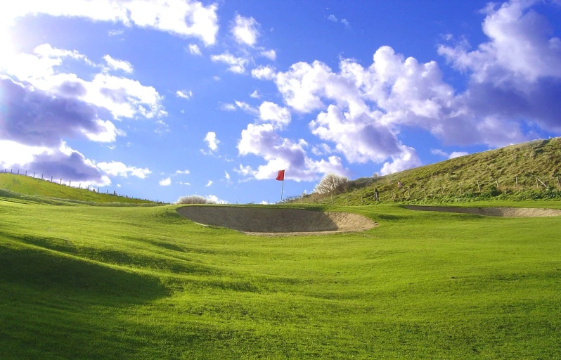 the rolling hills rise above the open area