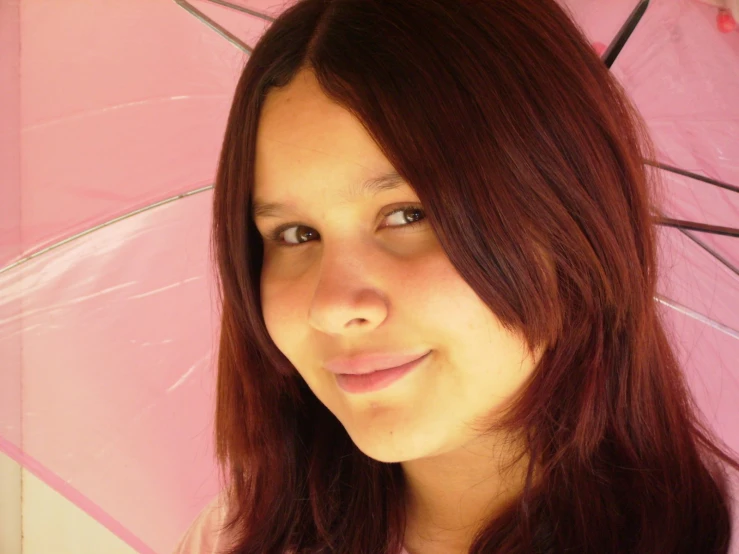 a women who has red hair and is holding an umbrella