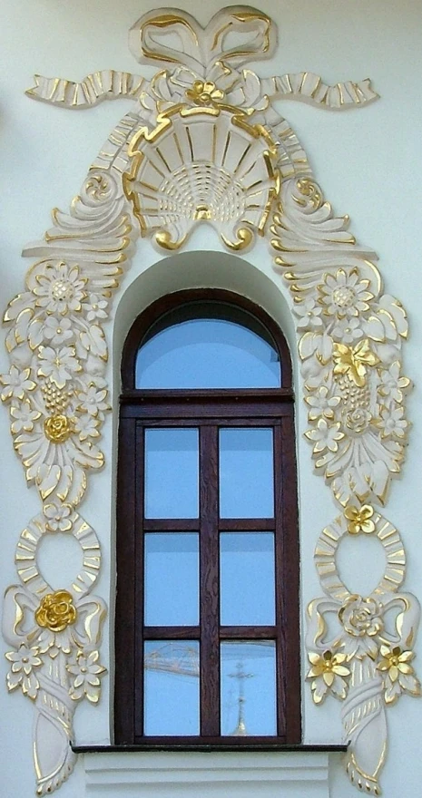 a window is in front of a white stucco wall