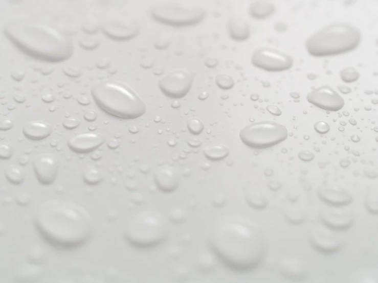 water drops are scattered across the white surface