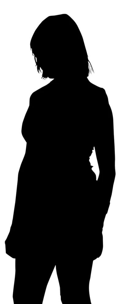 the silhouette of a woman in a coat holding a camera