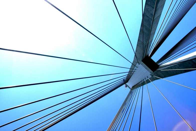 a view looking up at the side of a bridge