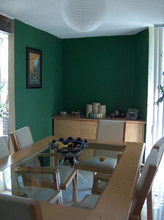 the glass table is near a cabinet and a glass door