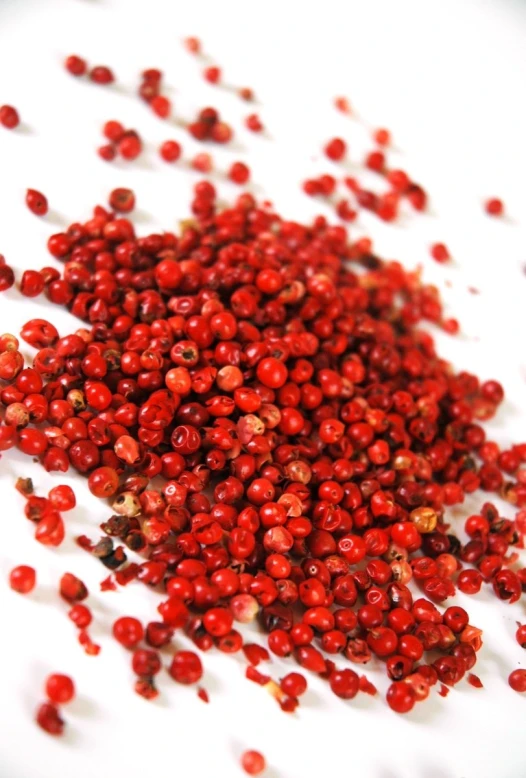 a pile of red sugar sits on a white surface