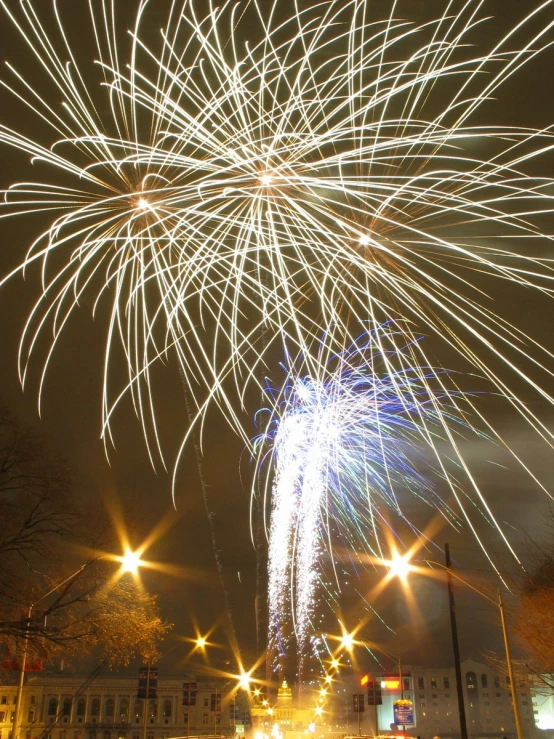 many fireworks and sparks exploding in the night sky