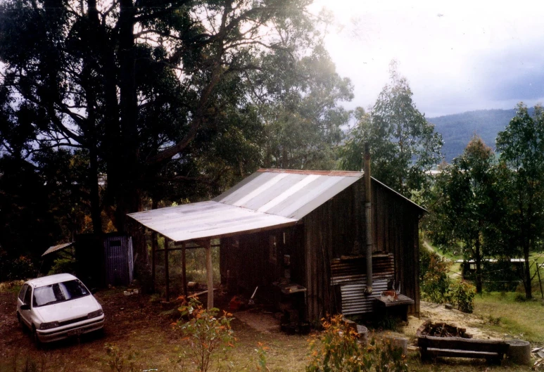 there is a small cabin next to the parked car