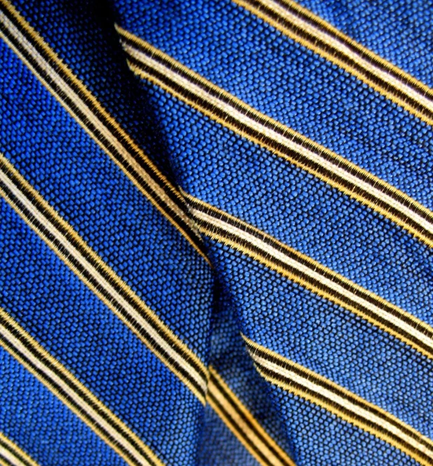 closeup of a blue and gold striped tie