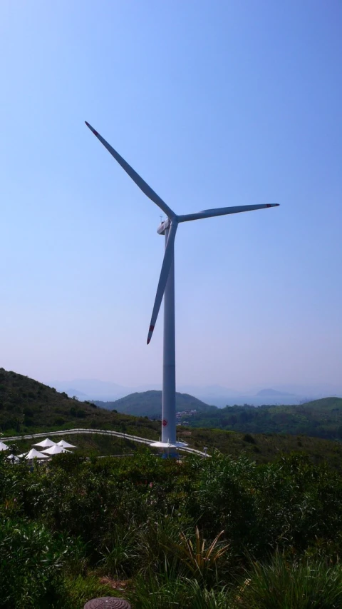 an overview of a wind turbine standing in a field