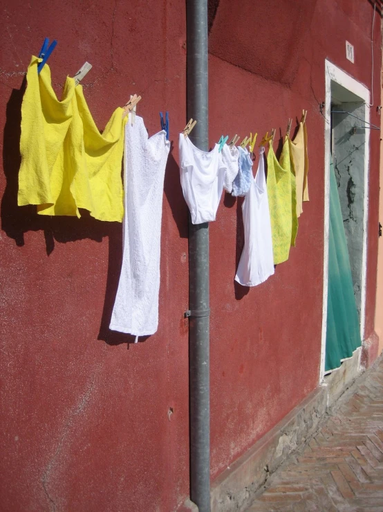 clothing hanging on a clothes line on a street
