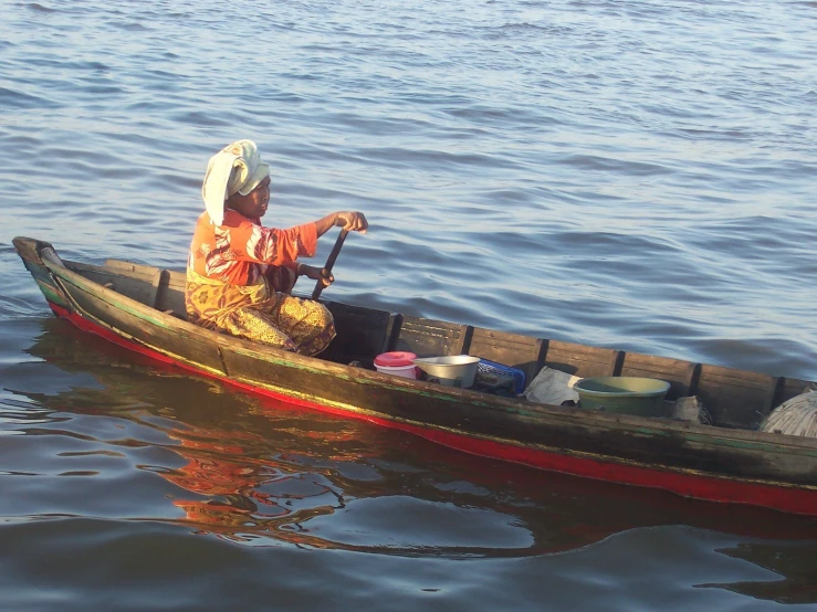 a person sitting in a boat on a body of water