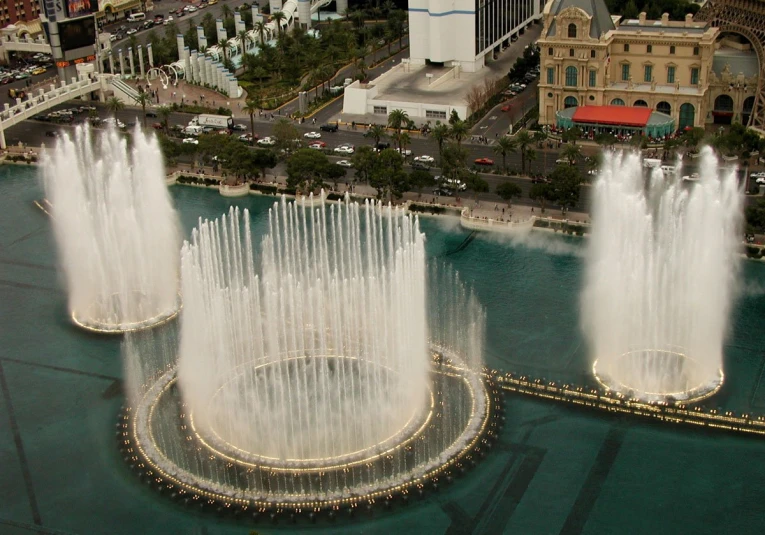 a couple of fountains of water in front of some buildings