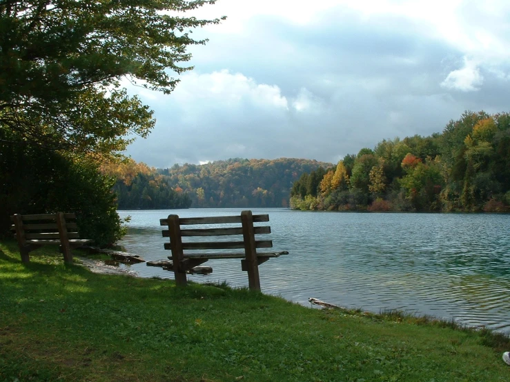 wooden bench overlooking a peaceful lake and forest