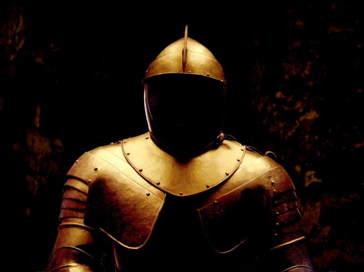 a man in armor sitting down with a black background