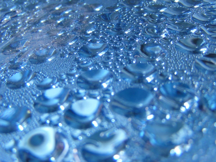 blue water is shown with many small drops